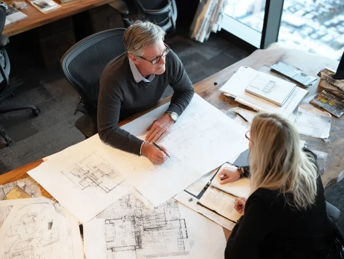 Acoustical consultant reviewing floor plans with client