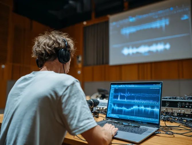 Audio engineer analyzing room acoustics with frequency measurement software