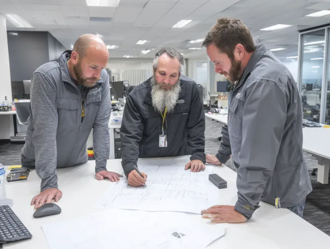 Team reviewing door noise levels in a building