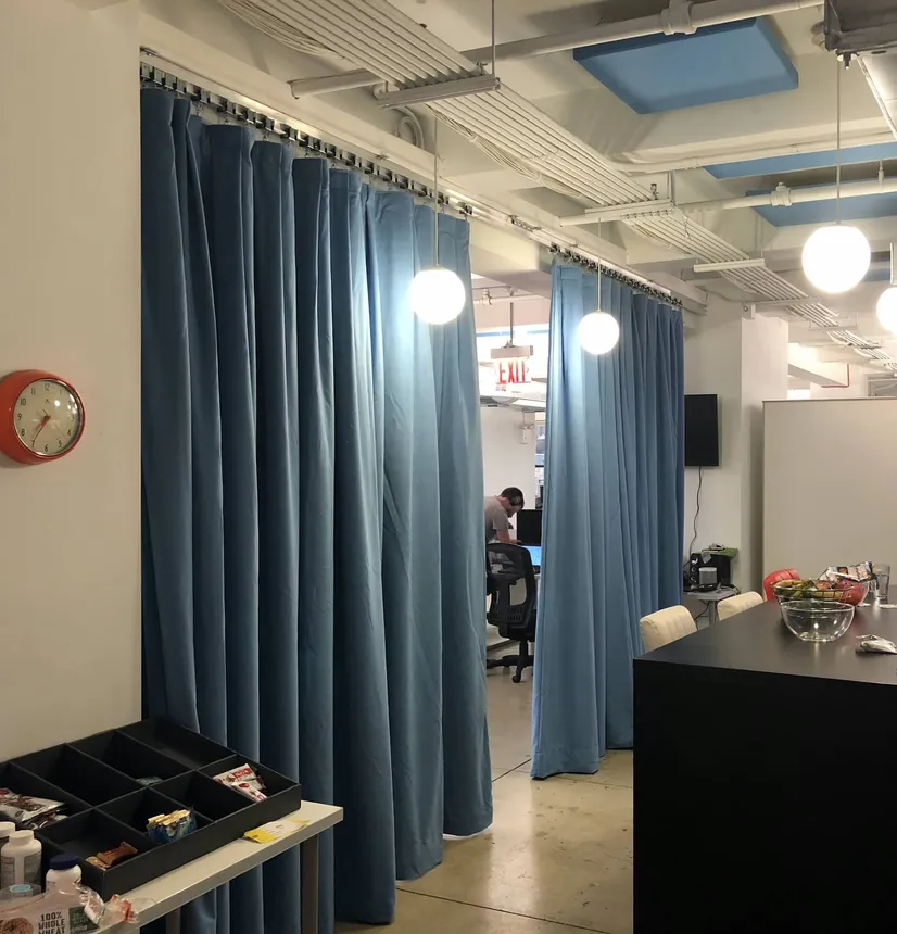 Light Blue Acoustic Curtain with Matching Ceiling Panels in Office